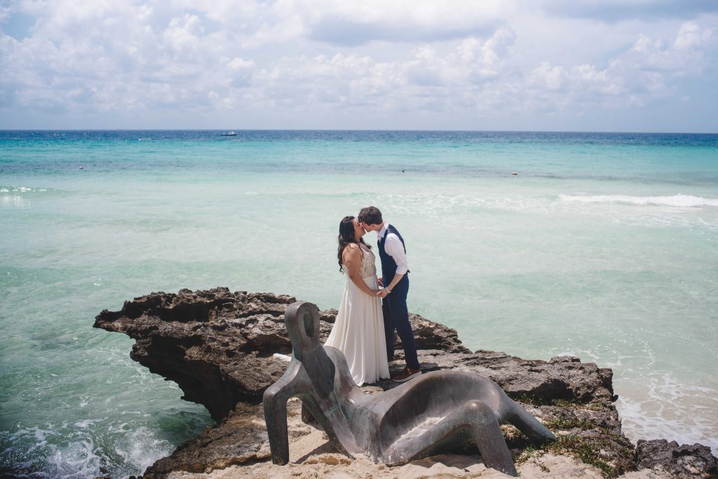 Couple posing on beach overlook at Casa De La Playa post-wedding